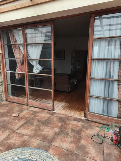 Puertas antiguas de madera con vidrios divididos que dan a una terraza
